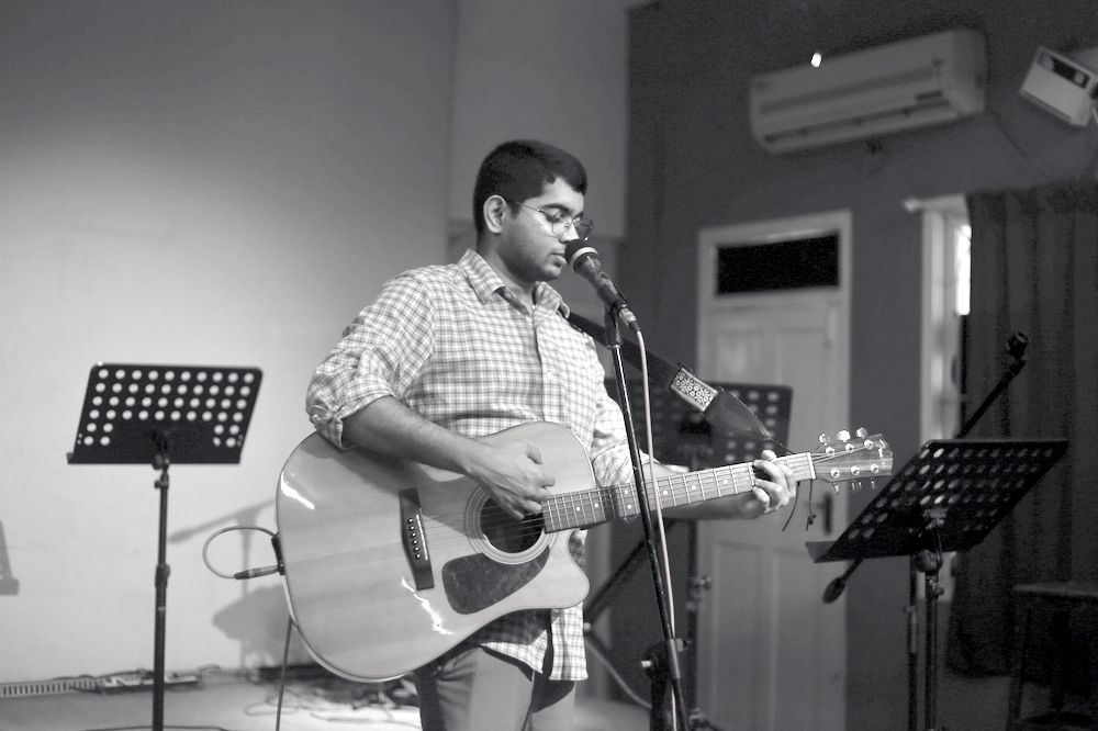 Worship leader singing and playing acoustic guitar