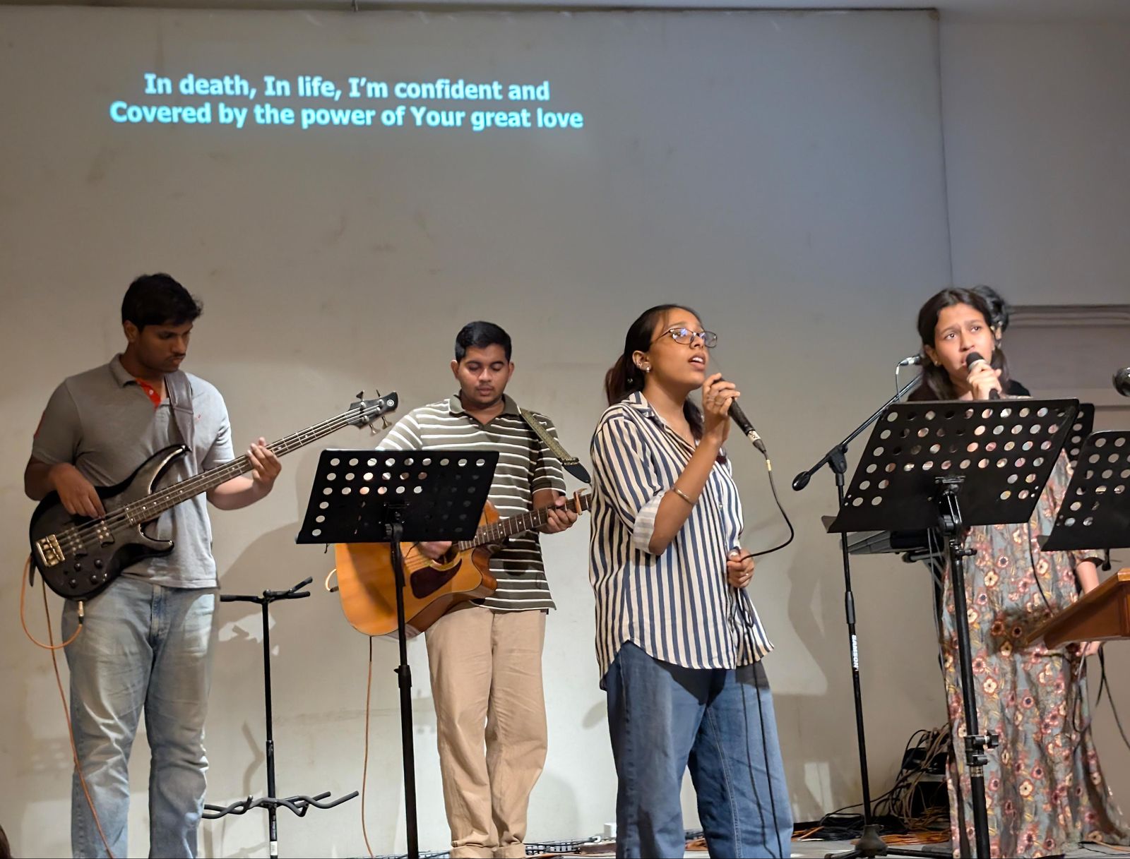 Bass, acoustic guitar and two vocalists leading Sunday worship